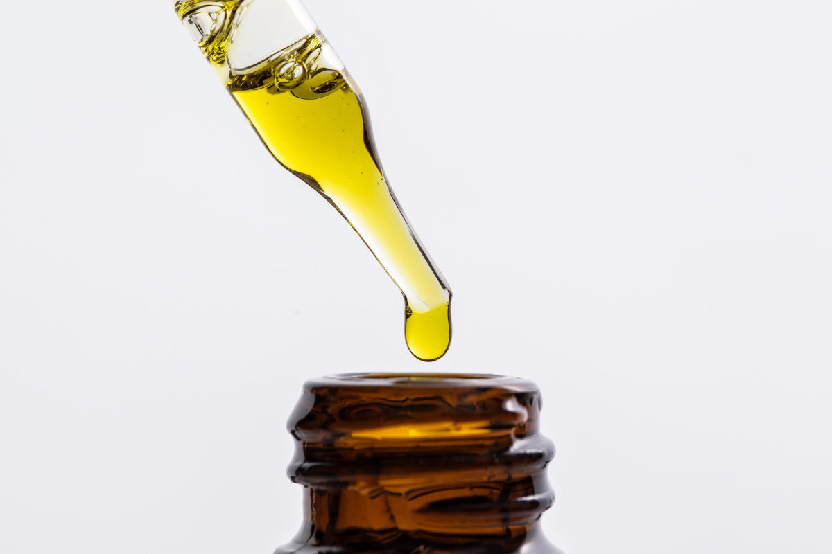 image of tincture dropping into bottle
